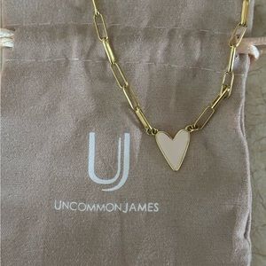 Enamel heart necklace gold off white color looks like a very light pink.